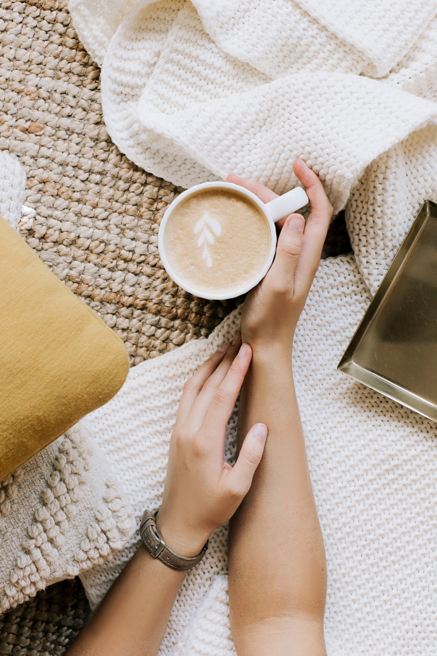 Crop anonymous woman with cup of hot cappuccino